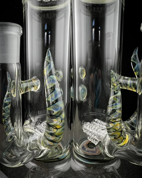 Artistic glass fish sculptures inside clear containers.