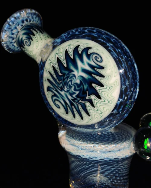 Hand-blown glass marble with intricate blue swirl pattern.